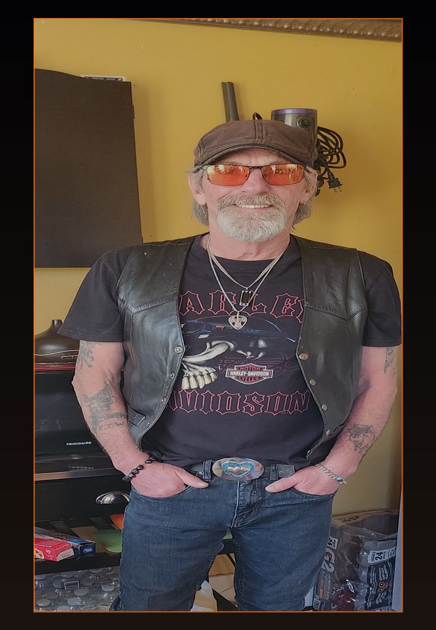 Johnny Phoenix standing against a dark background